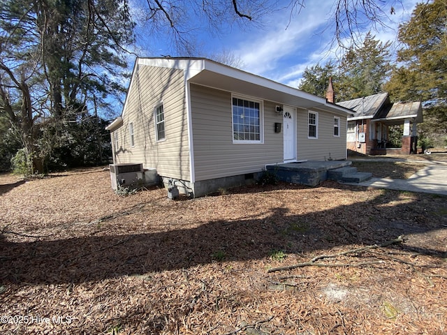 view of front of house featuring crawl space and central AC unit