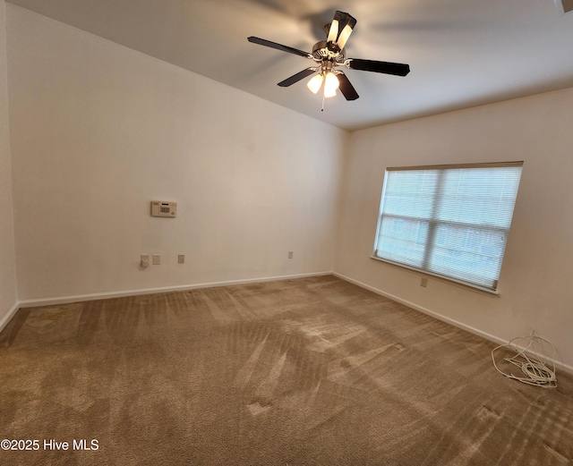 spare room with carpet, baseboards, and ceiling fan