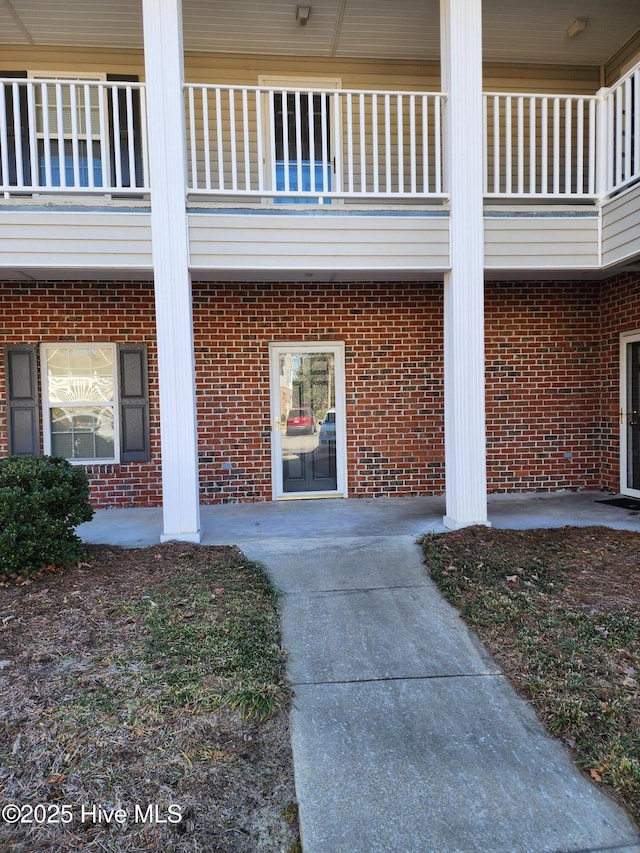 property entrance with brick siding