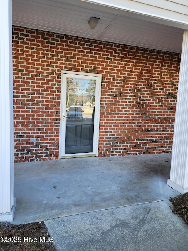 exterior space featuring a patio and brick siding