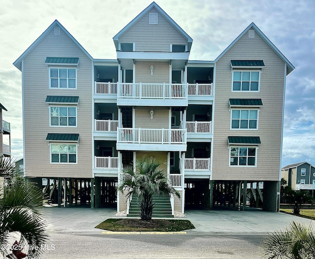 view of building exterior with driveway and a carport