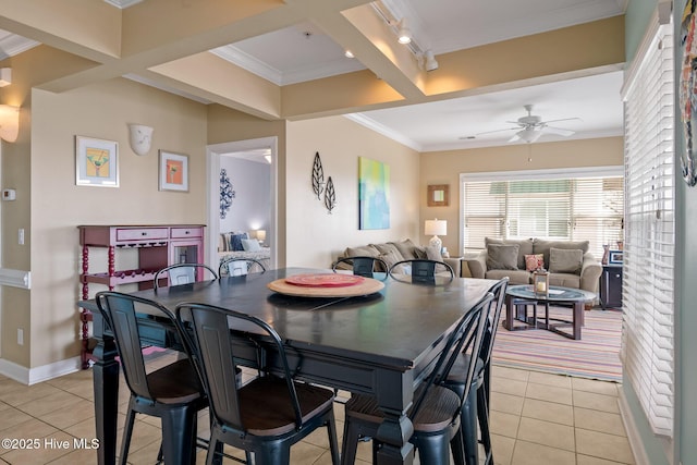 dining area with light tile patterned floors, baseboards, a ceiling fan, rail lighting, and crown molding