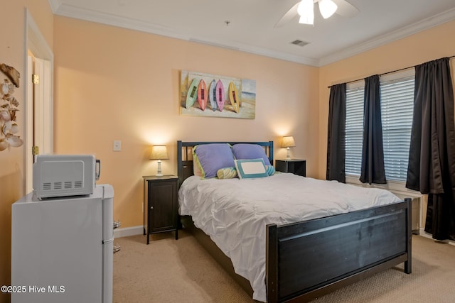 bedroom featuring visible vents, baseboards, a ceiling fan, light colored carpet, and ornamental molding