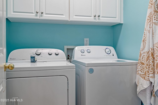 laundry room with cabinet space and washing machine and clothes dryer