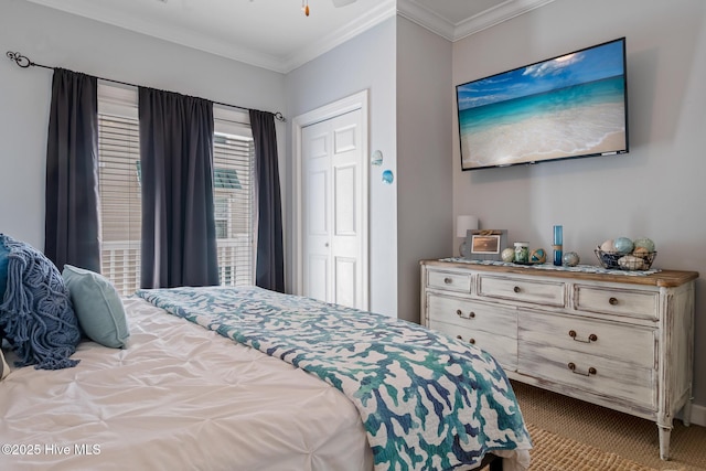 bedroom featuring ornamental molding, a closet, and carpet flooring