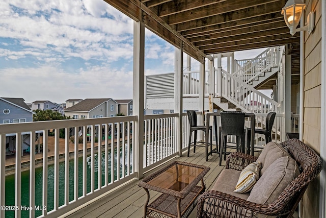 balcony featuring a residential view and stairway