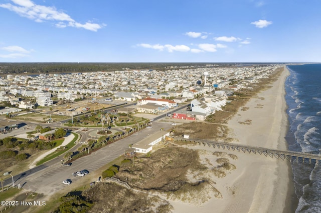 birds eye view of property with a water view and a view of the beach