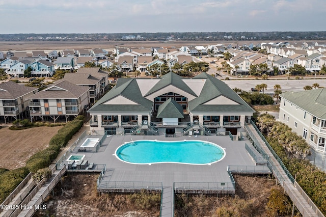 community pool with a patio area and a residential view