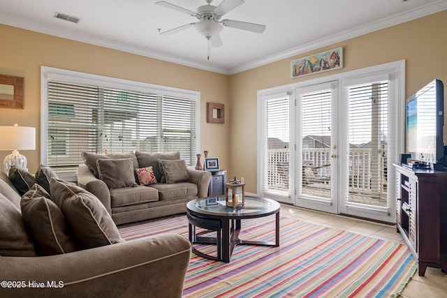 living room with ceiling fan, ornamental molding, light tile patterned flooring, and visible vents