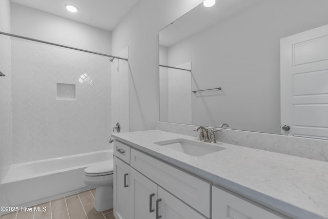 full bath with washtub / shower combination, vanity, and toilet