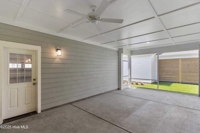 unfurnished sunroom with a ceiling fan