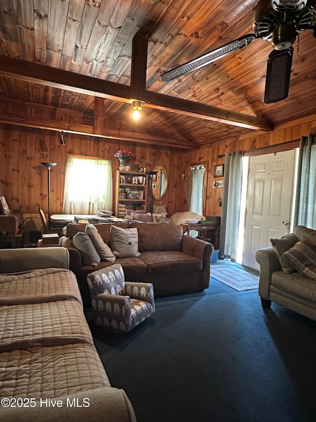 carpeted living room with beamed ceiling, wood walls, and wooden ceiling