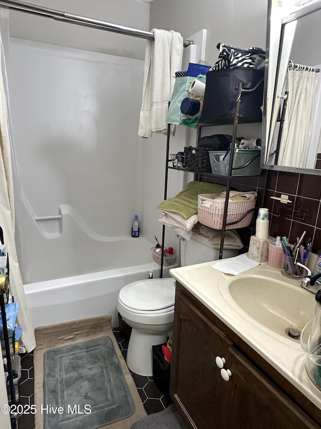 full bath with tile patterned flooring, toilet, vanity, tasteful backsplash, and shower / bath combination with curtain