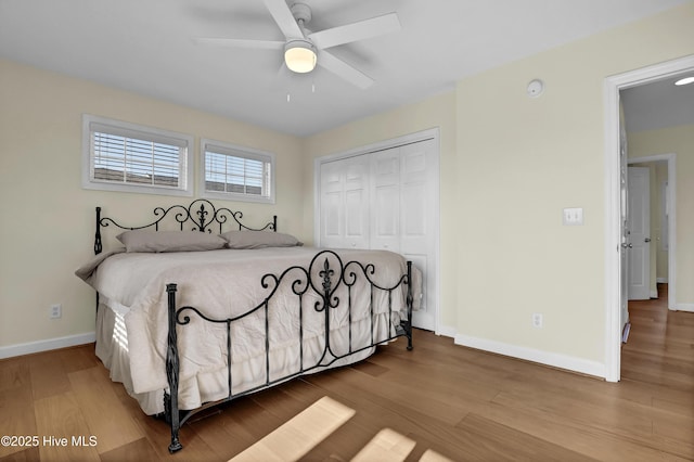 bedroom with a ceiling fan, a closet, baseboards, and wood finished floors