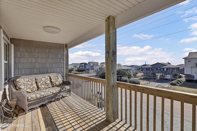 wooden deck with a residential view and an outdoor hangout area