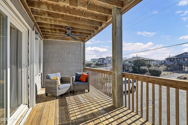 wooden deck featuring a ceiling fan and a residential view