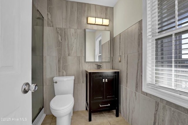 bathroom featuring a shower, tile patterned flooring, vanity, and toilet