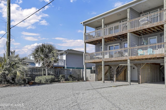 view of property featuring a carport and fence