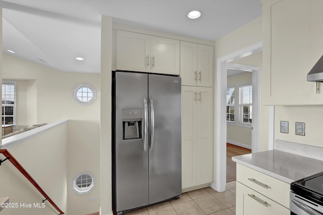 kitchen with recessed lighting, light tile patterned flooring, stainless steel refrigerator with ice dispenser, and white cabinetry