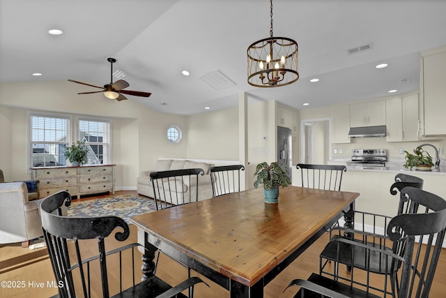 dining area featuring ceiling fan with notable chandelier, lofted ceiling, visible vents, and recessed lighting