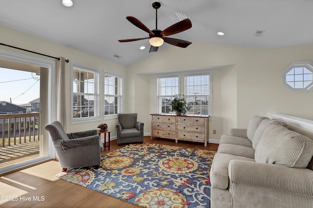 living area featuring recessed lighting, visible vents, vaulted ceiling, and wood finished floors