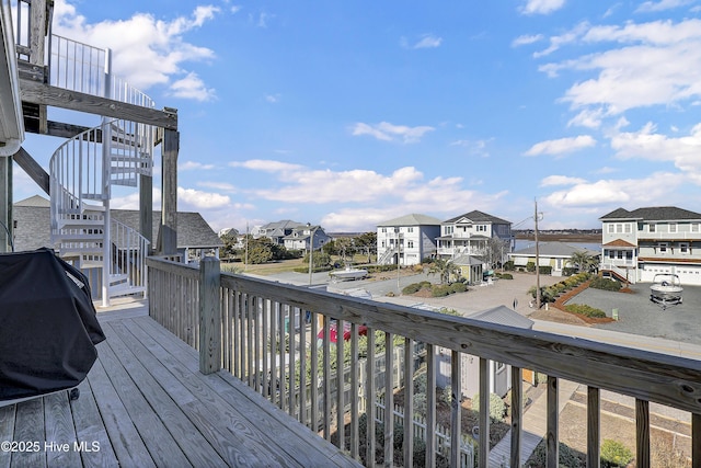 deck featuring a residential view, stairway, and grilling area