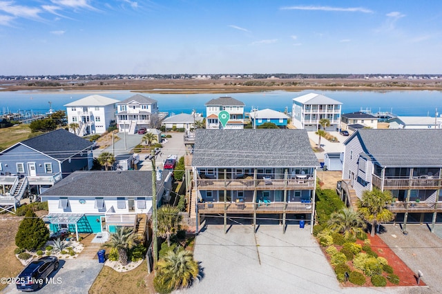 birds eye view of property with a water view and a residential view