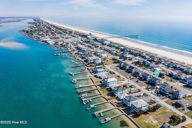 drone / aerial view featuring a water view and a view of the beach