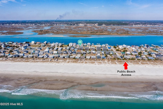 birds eye view of property featuring a beach view, a water view, and a residential view