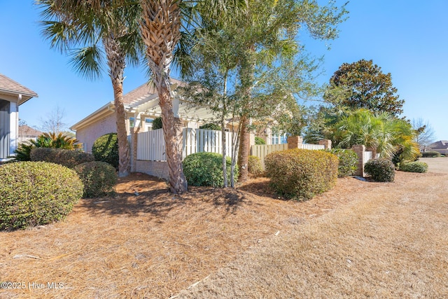 view of home's exterior with fence