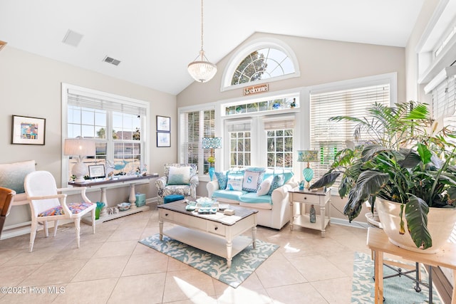 sunroom featuring lofted ceiling and visible vents