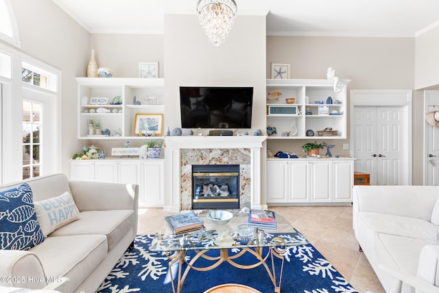 living area with a fireplace, a chandelier, crown molding, and light tile patterned flooring