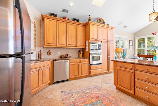 kitchen featuring light tile patterned floors, visible vents, light stone countertops, vaulted ceiling, and stainless steel appliances