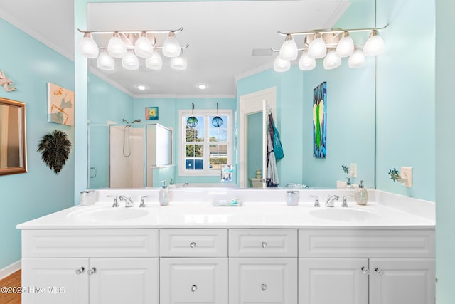 full bathroom with a sink, a shower stall, and crown molding