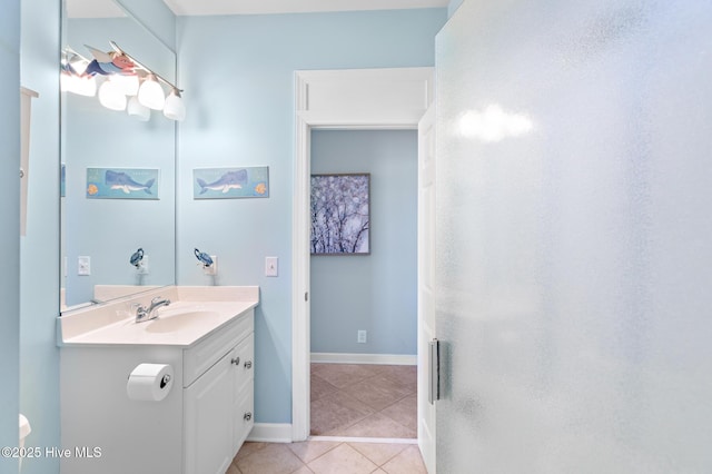 bathroom featuring tile patterned flooring, vanity, and baseboards