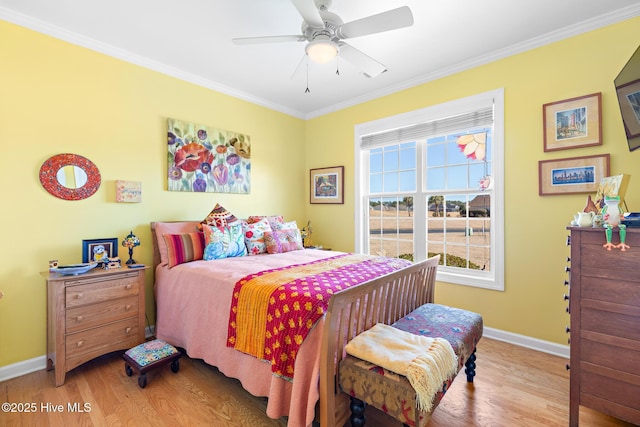 bedroom with baseboards, ornamental molding, and wood finished floors