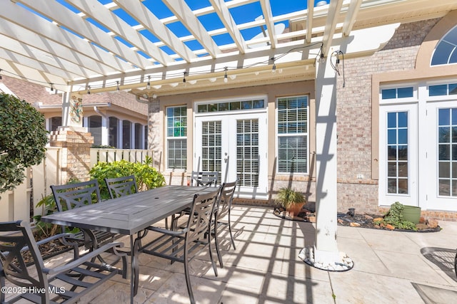 view of patio / terrace with french doors, outdoor dining space, and a pergola