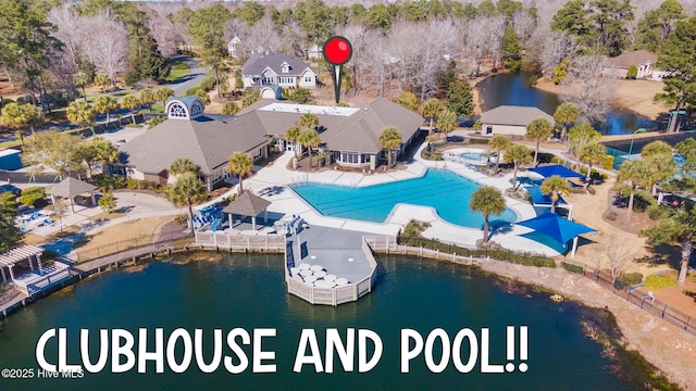 birds eye view of property with a water view and a residential view