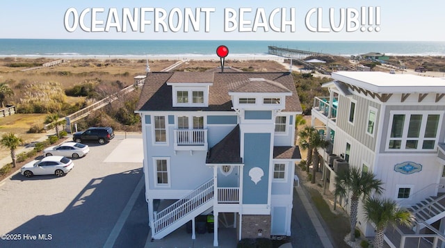 bird's eye view with a water view and a beach view