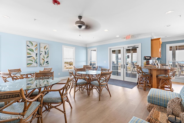 dining room with french doors, crown molding, recessed lighting, light wood-type flooring, and baseboards