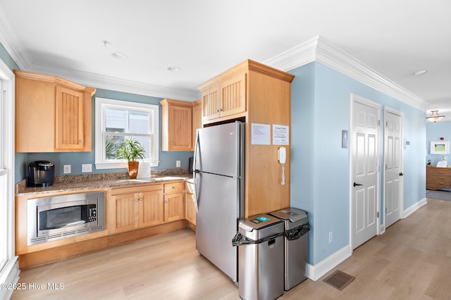 kitchen with stainless steel appliances, ornamental molding, light brown cabinets, and visible vents