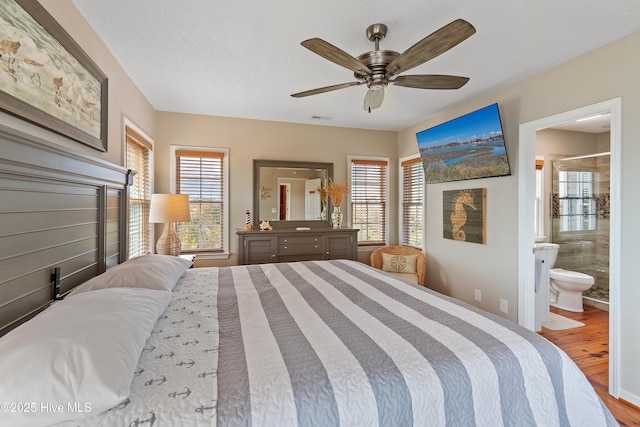 bedroom featuring a textured ceiling, ceiling fan, wood finished floors, and connected bathroom