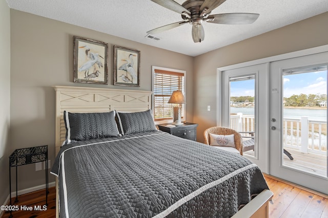 bedroom featuring access to exterior, french doors, visible vents, and multiple windows