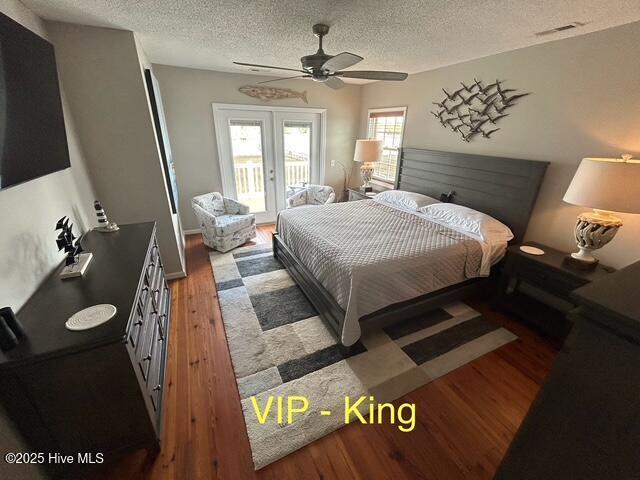 bedroom featuring a textured ceiling, visible vents, access to outside, french doors, and light wood finished floors