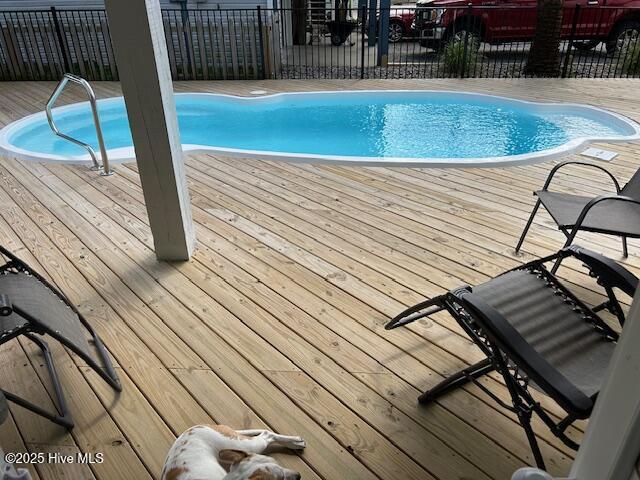 view of swimming pool featuring fence and a fenced in pool