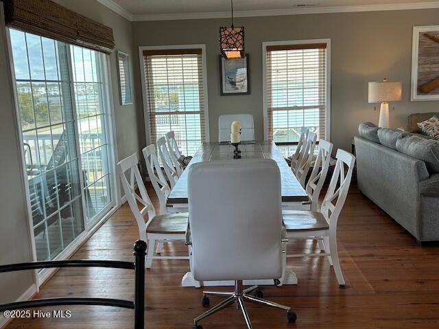 dining room featuring ornamental molding and wood finished floors