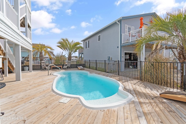 view of pool with a fenced in pool, a patio area, fence, and a wooden deck