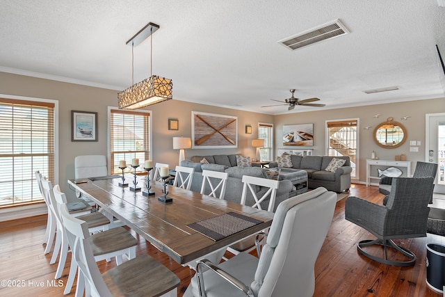 dining room featuring light wood-style floors, visible vents, and a wealth of natural light