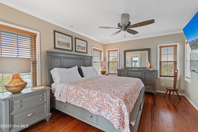 bedroom with dark wood-style floors, crown molding, a ceiling fan, a textured ceiling, and baseboards