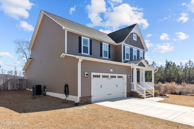 view of front of property with a garage, concrete driveway, cooling unit, and fence